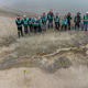 Paleontologists standing next to the ichthyosaur fossil.